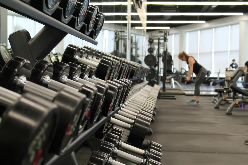 Heavy iron barbells loaded with calibrated plates on a competition platform